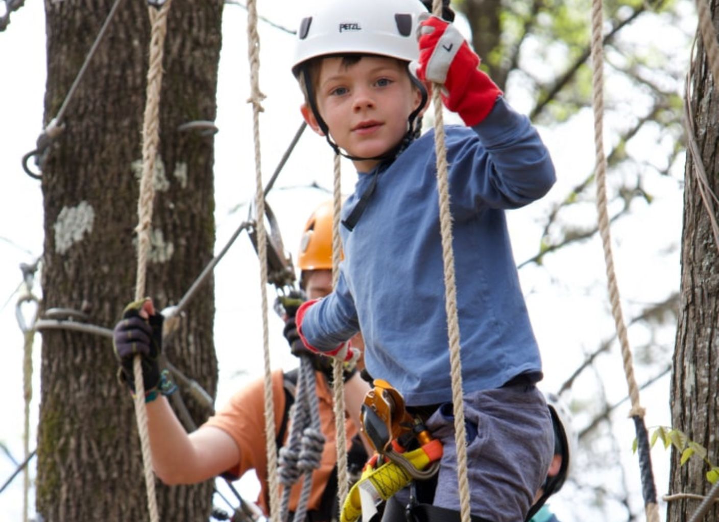 kids on aerial adventure challenge course and zipline